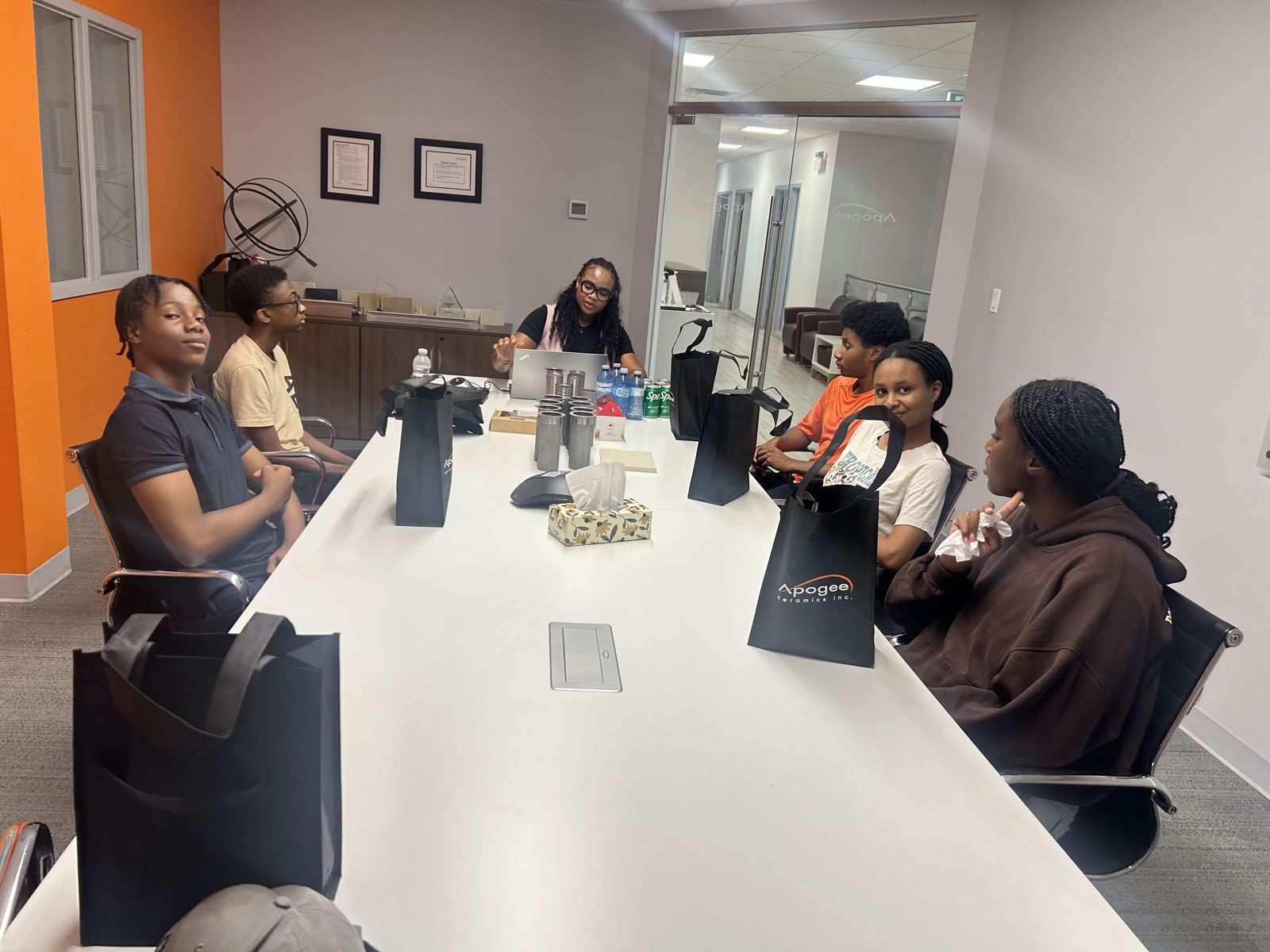 Black Youth in Business students meet their hosts in a boardroom during an industry visit.