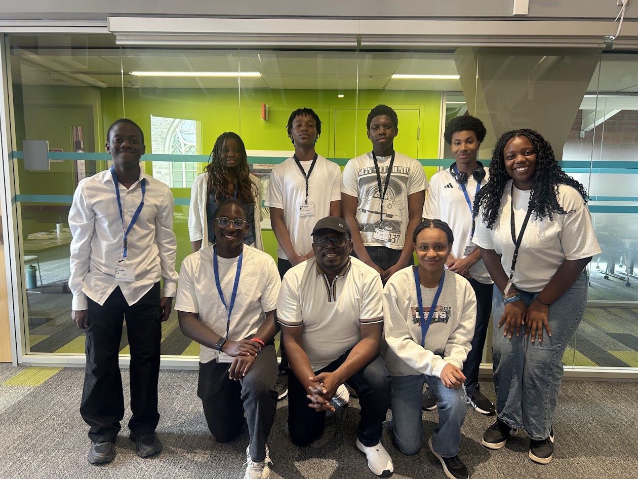 Emole youth volunteers and instructors smiling together at the Black Youth in STEM program in Kingston.