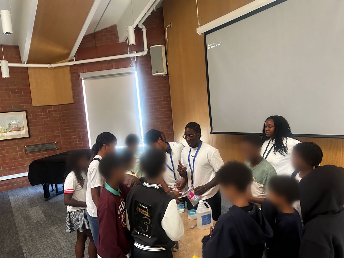 Youth volunteers guide younger students through a hands-on activity during Emole's Black Youth in STEM program.
